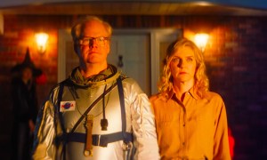 Jim Gaffigan wears a space suit while standing next to Rhea Seehorn in Linoleum.