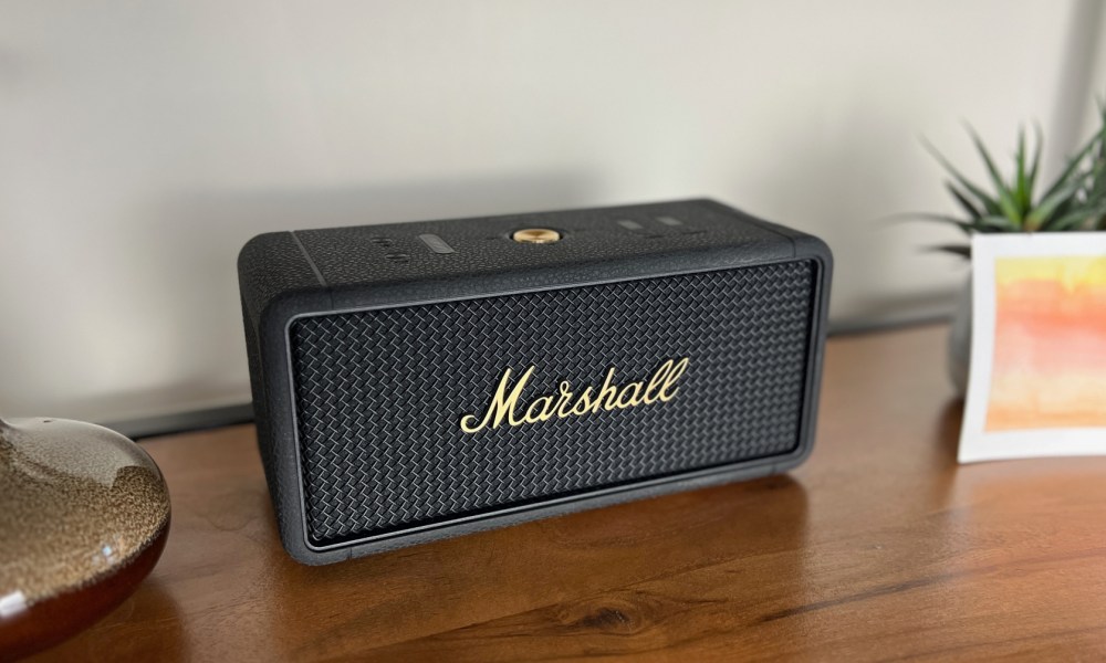 The Marshall Middleton Bluetooth speaker on a bookshelf.