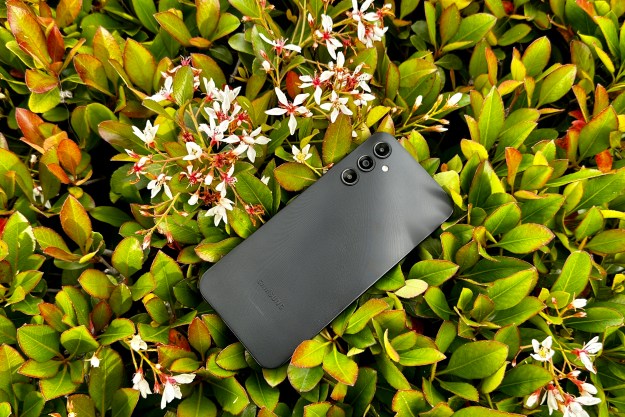 Samsung Galaxy A14 5G in a bush showing off the back of phone