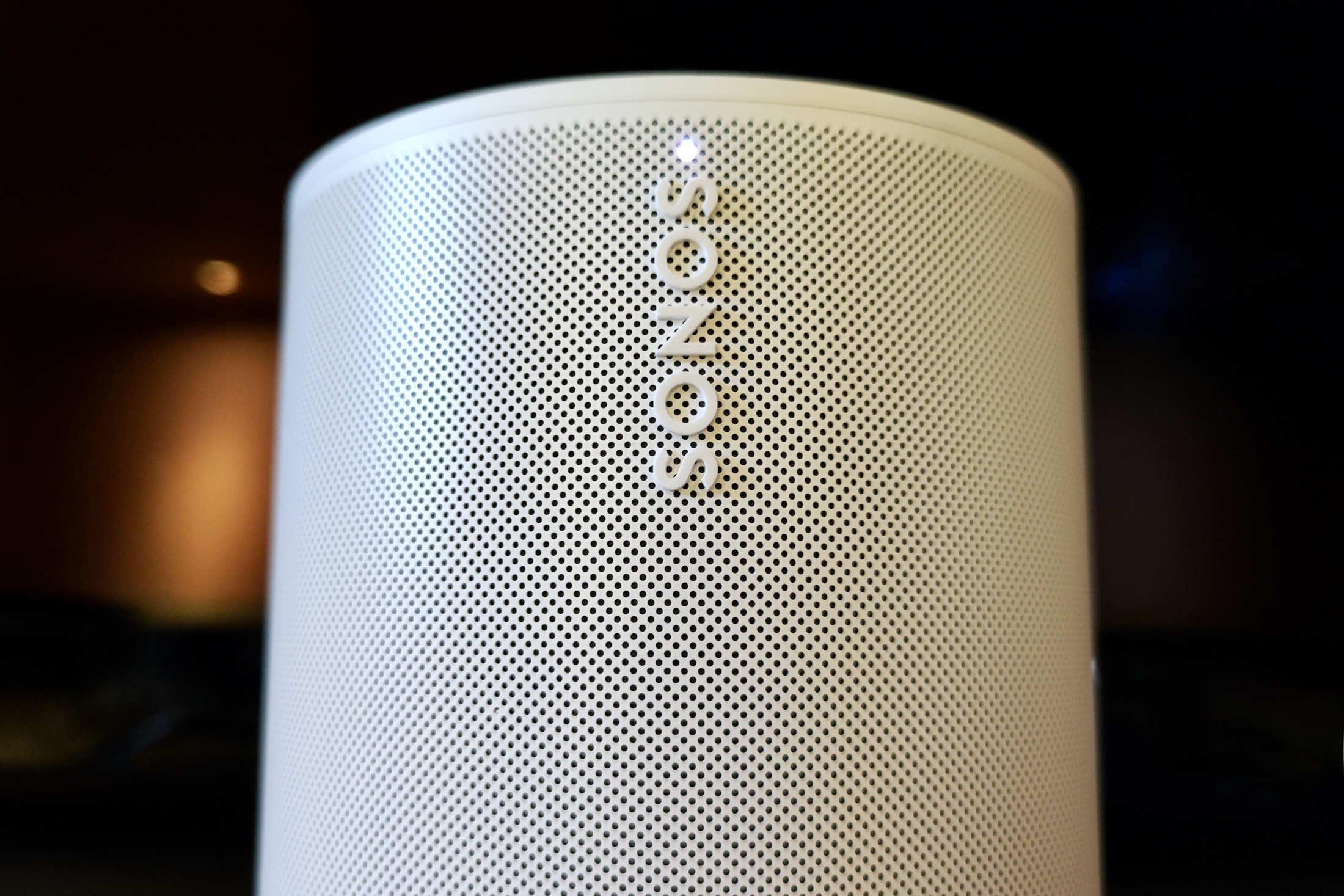 Sonos Era 100, close up on logo and indicator light.