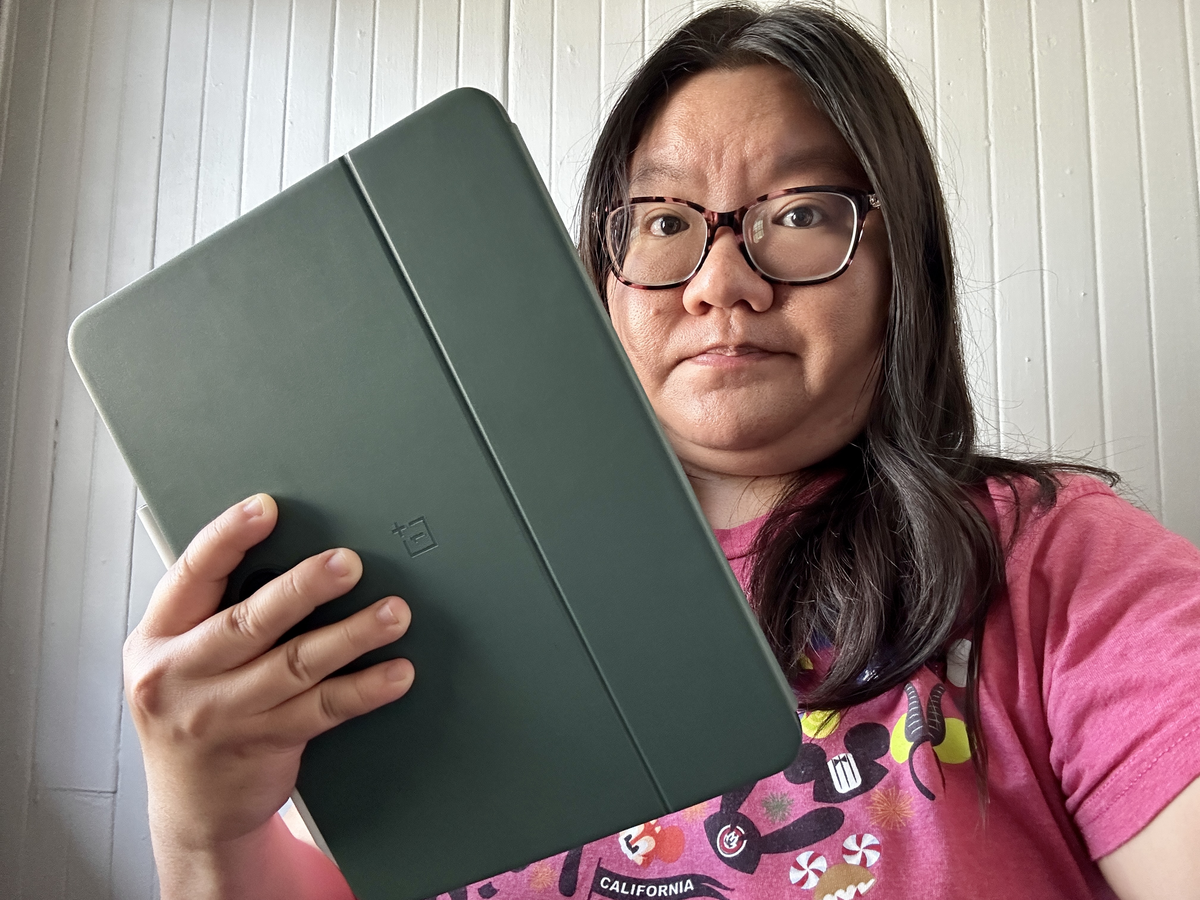 OnePlus Pad in Magnetic Keyboard Cover held in right hand by Christine, covering the weird camera placement