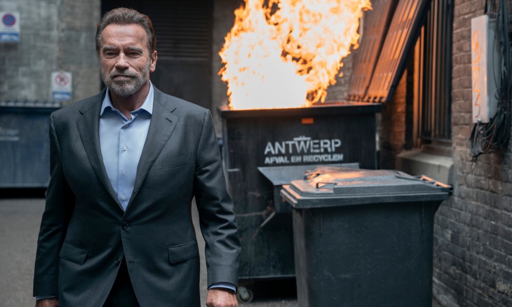 Arnold Schwarzenegger walks away from a trash fire in FUBAR.