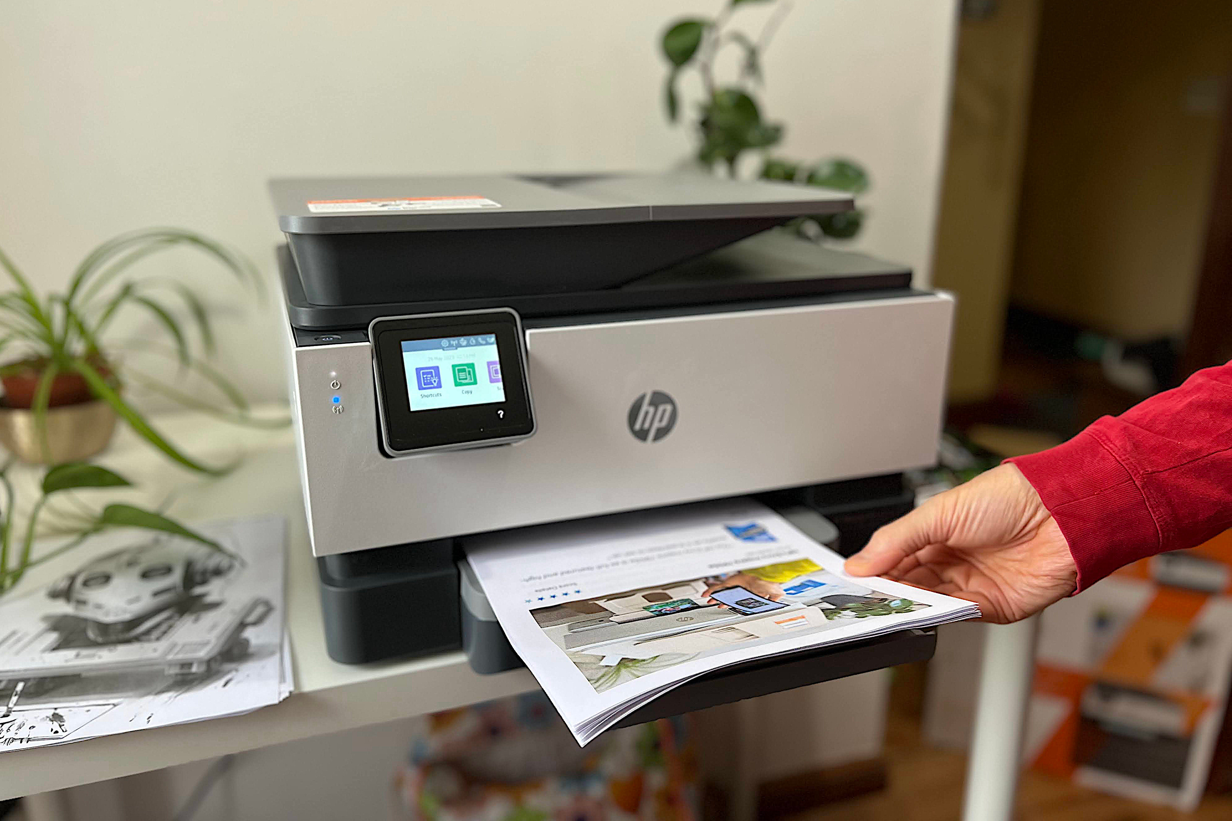 hp officejet pro 9015e printer review lifting a stack of documents from the s paper tray