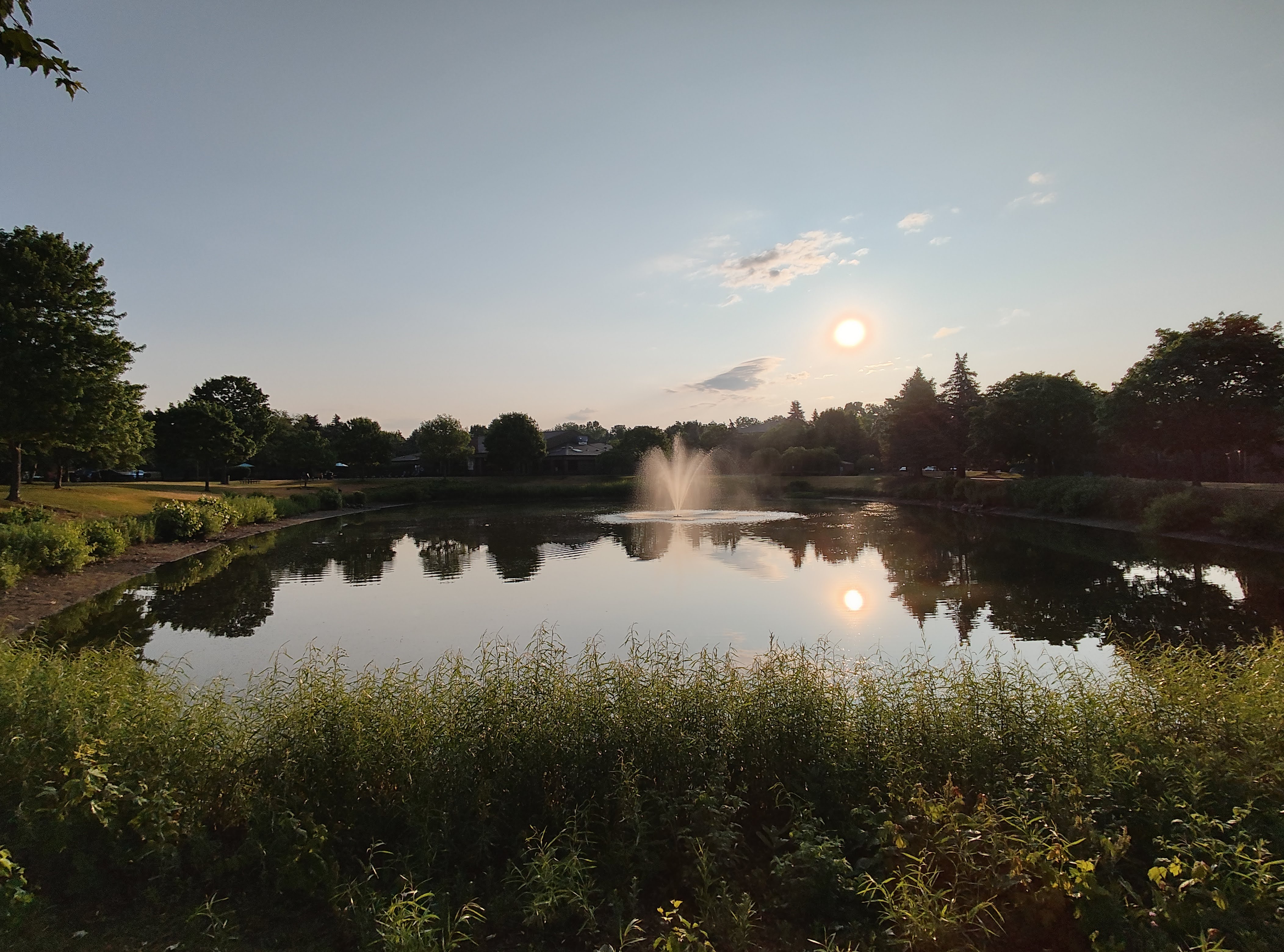 A photo of a pond with a fountain in it, taken with the Motorola Razr Plus.