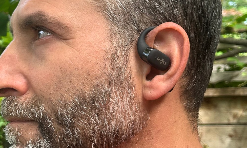 Man wearing Shokz OpenFit (side view).