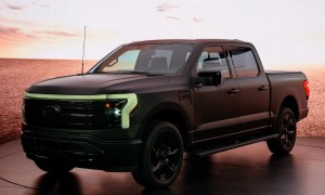 An F-150 Lightning Platinum Black model in dim lighting.