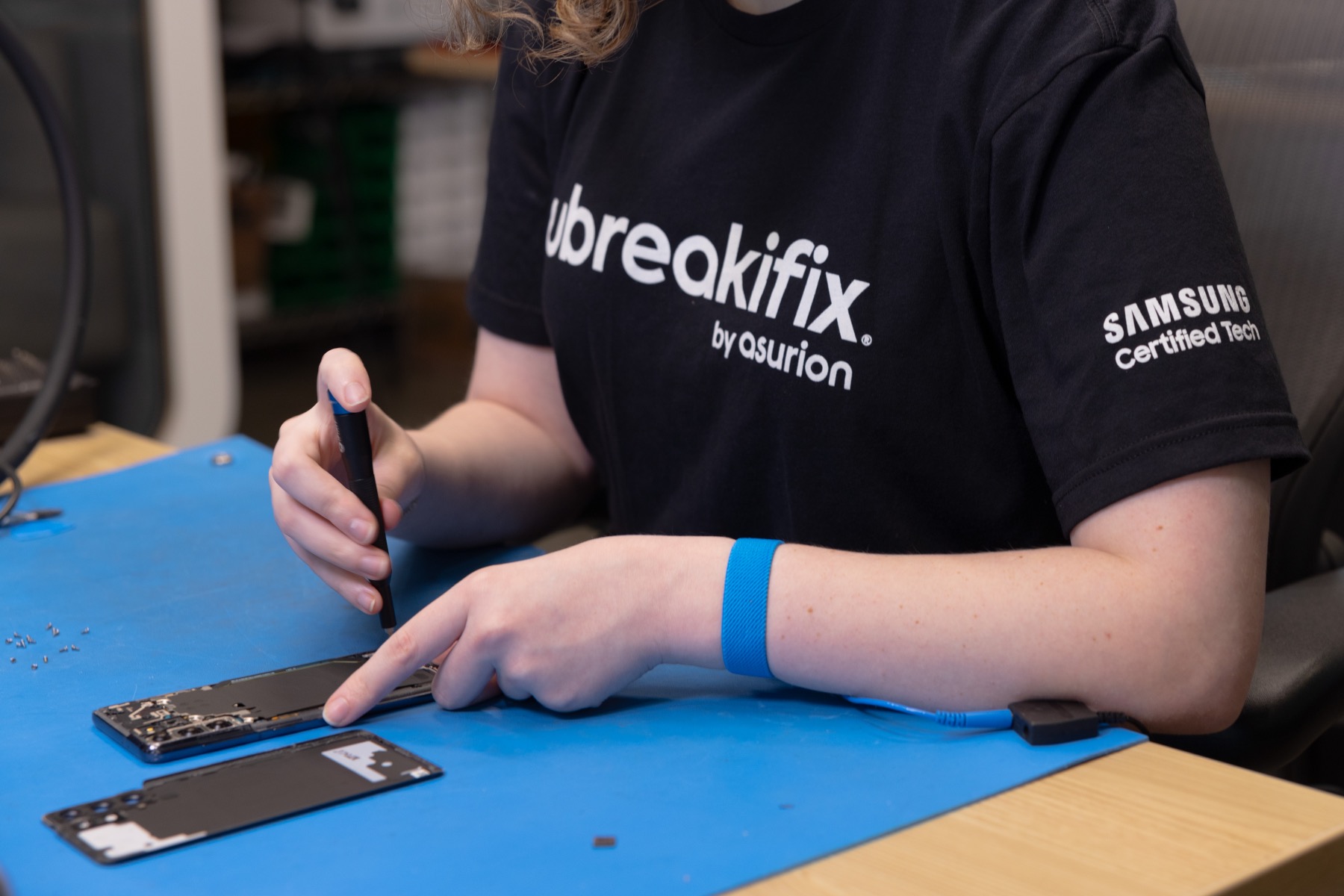 A person repairing a Samsung phone