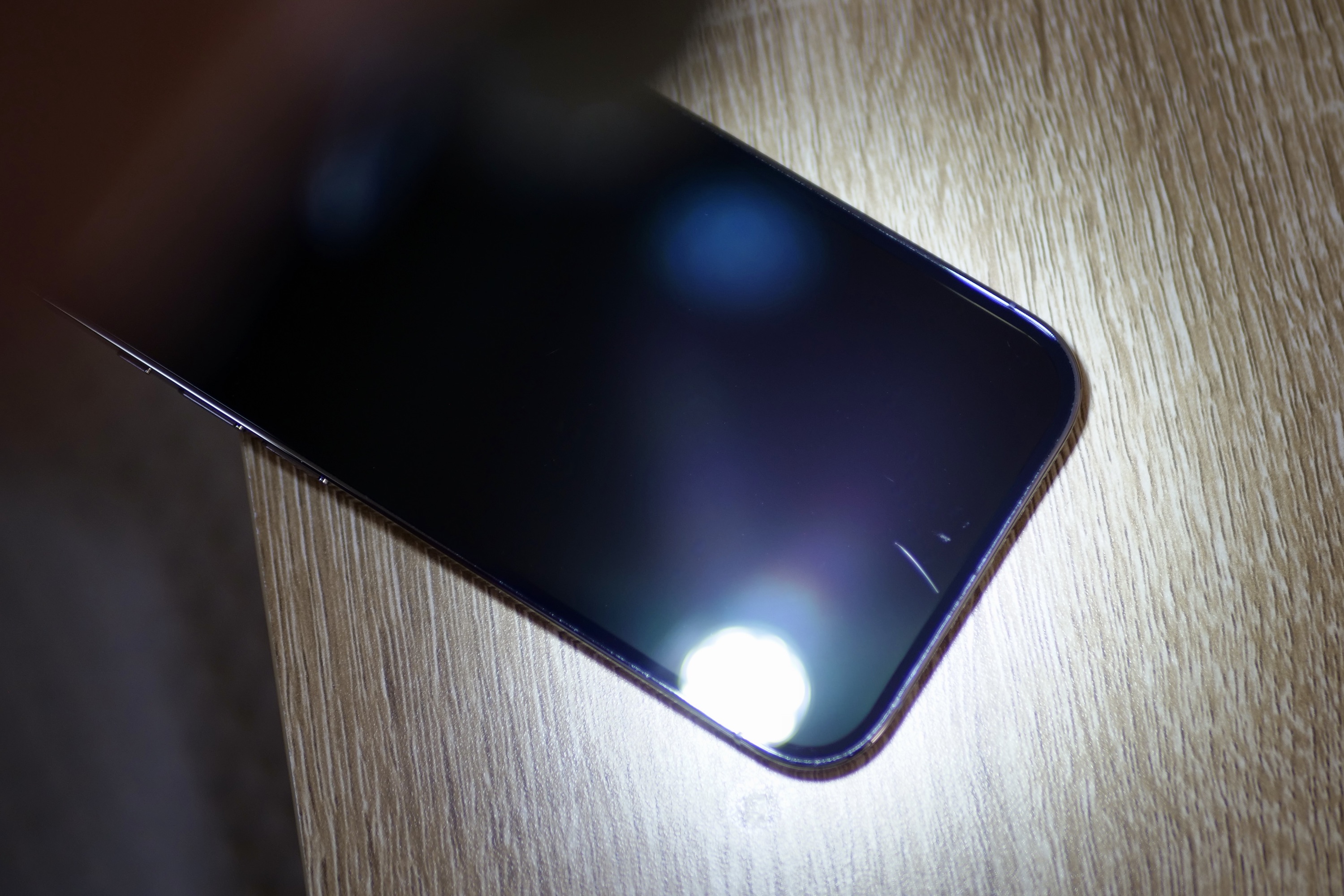 Ceramic Shield on the iPhone 14 Pro, with light to show scratches.