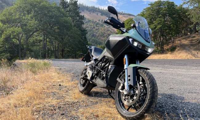 A 2023 Zero DSR-X electric adventure motorcycle sits parked on the side of the road.