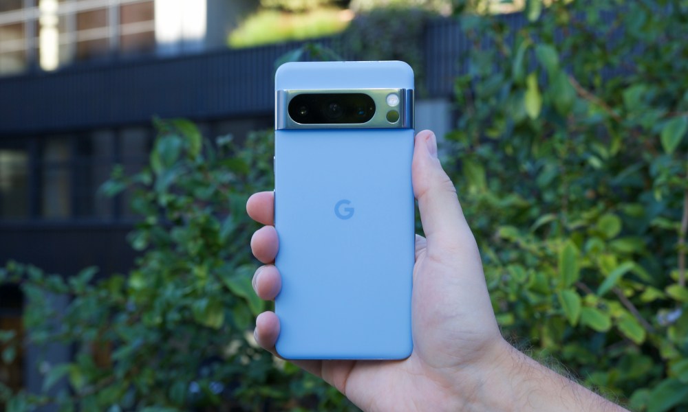 A person holding the blue Google Pixel 8 Pro.