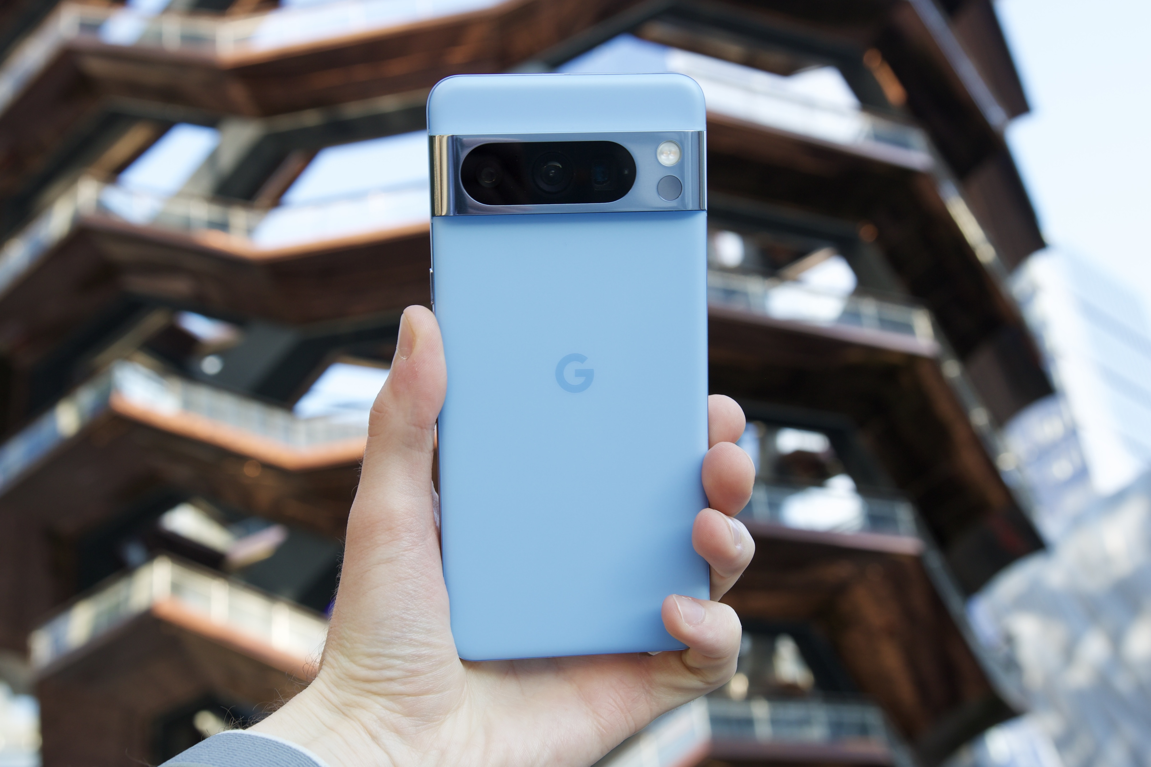 Someone holding the Bay blue Google Pixel 8 Pro.