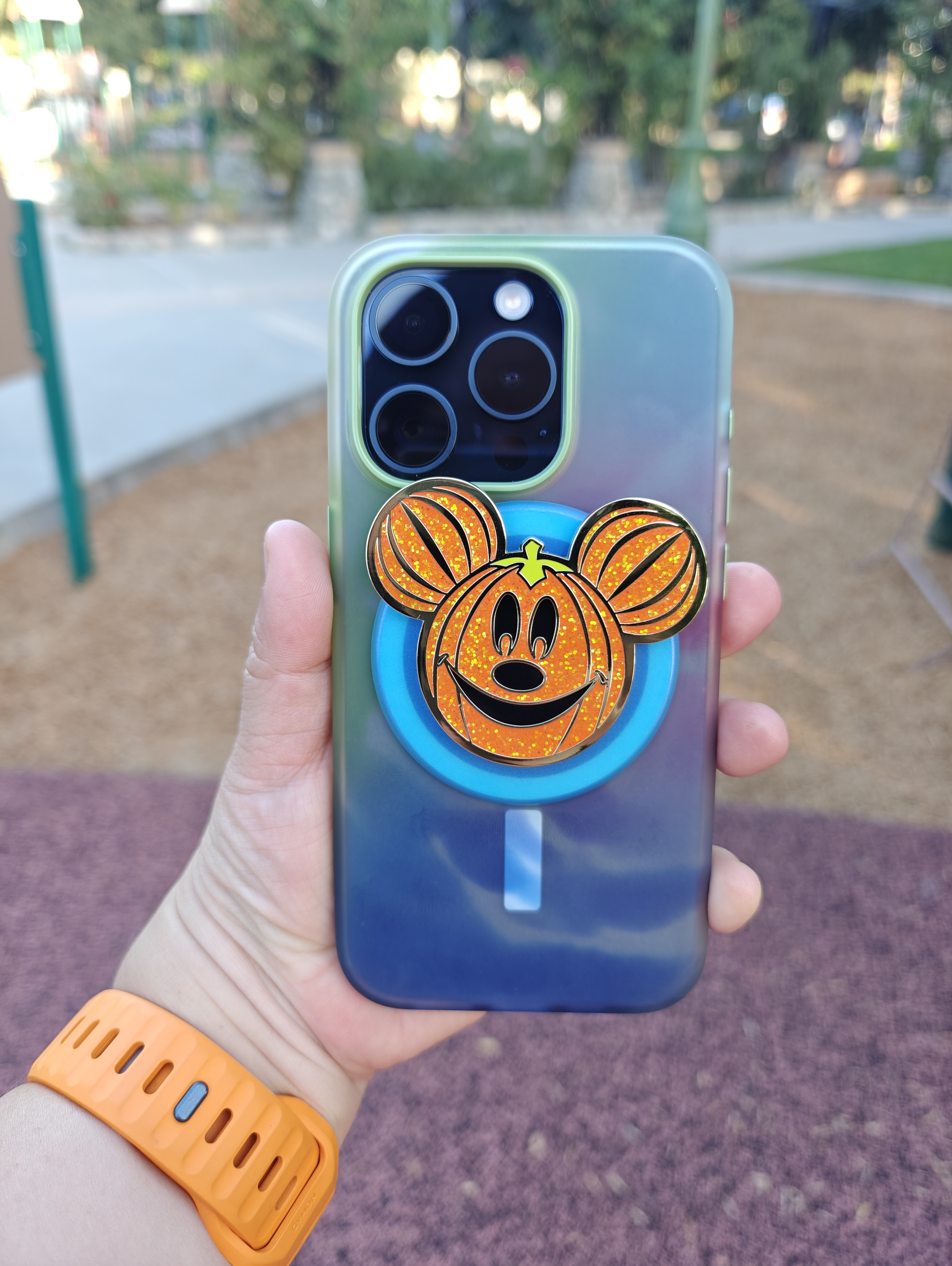 iPhone 15 Pro in OtterBox Figura Case with Mickey Pumpkin PopSocket.