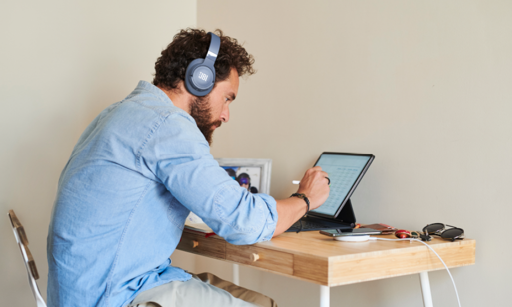 The JBL Tune 760NC wireless headphones on someone's head.