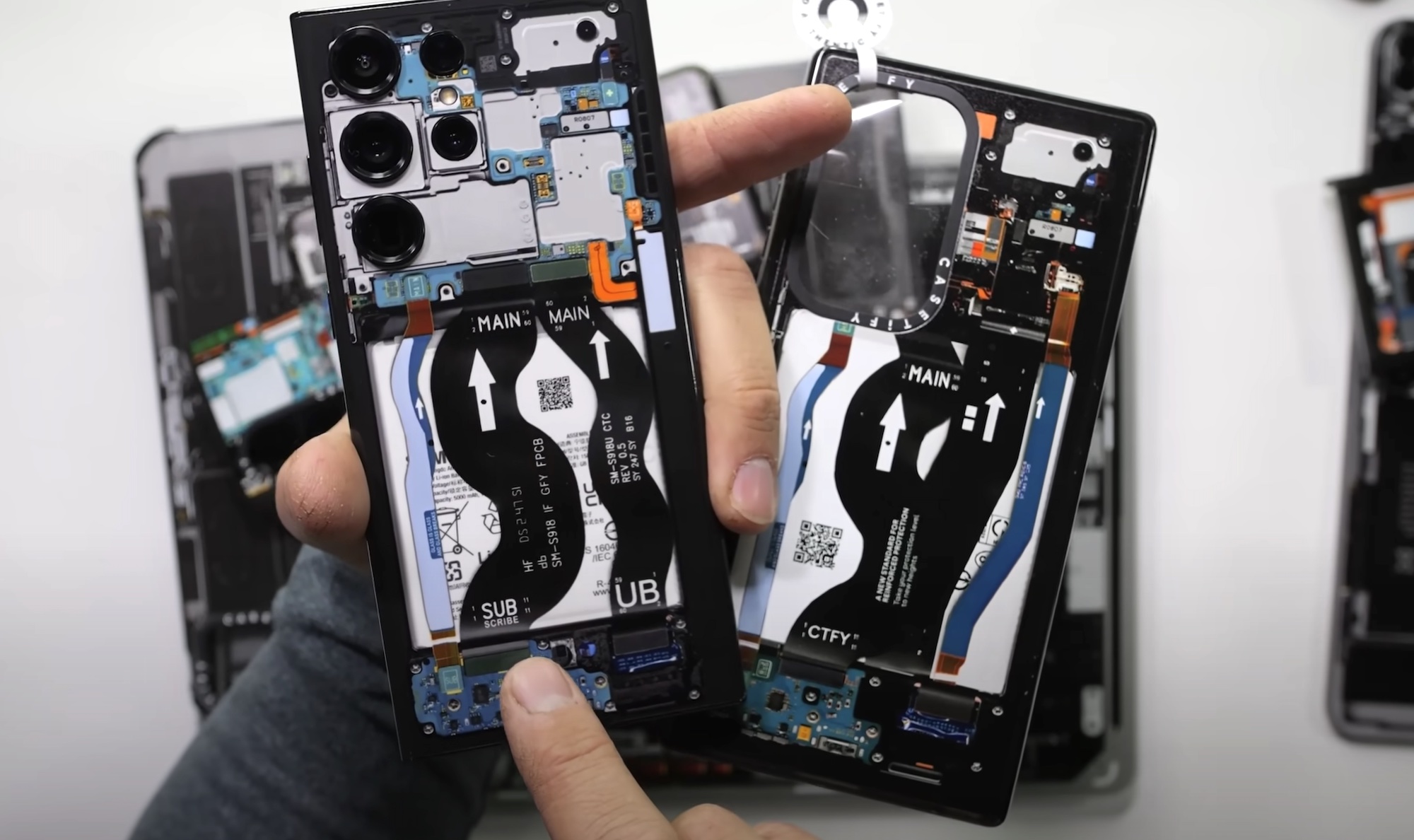 A dbrand Teardown case alongside one by Casetify.