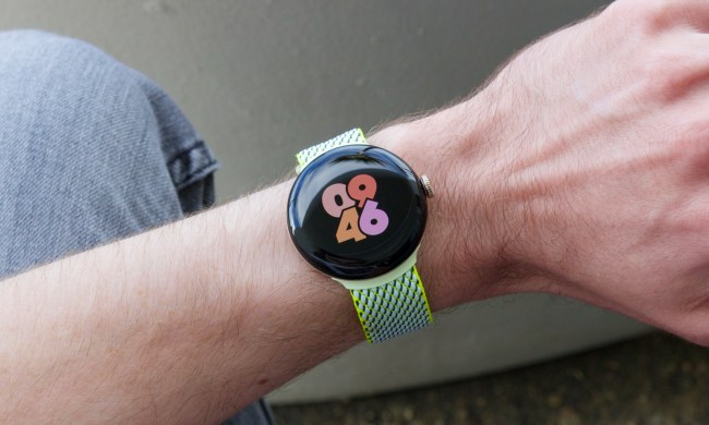 A person sitting down and wearing the Google Pixel Watch 2.