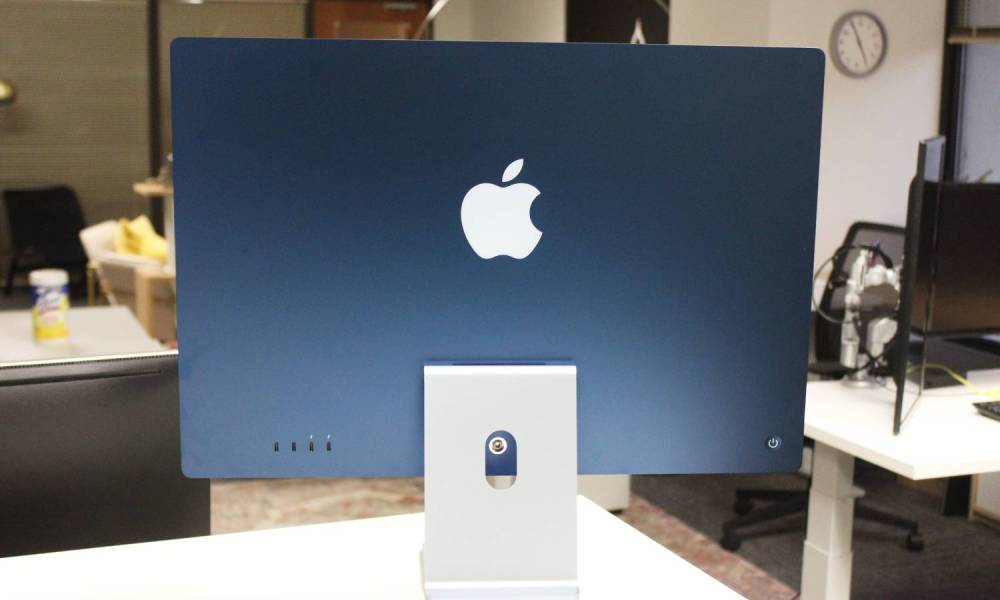 The back of the Blue iMac on a desk in an office.