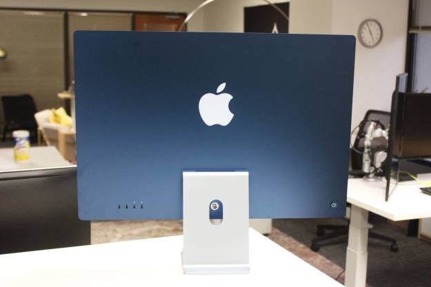 The back of the Blue iMac on a desk in an office.