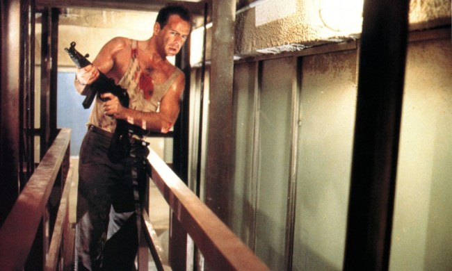 John McClane holds a gun in Die Hard.