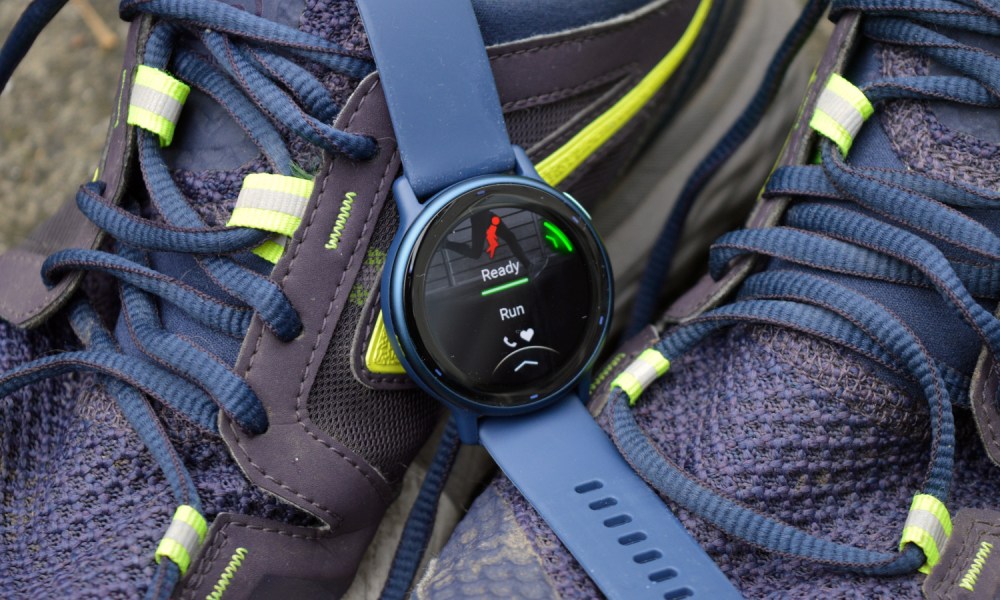 The Garmin Vivoactive 5 laid on some running shoes, close-up.