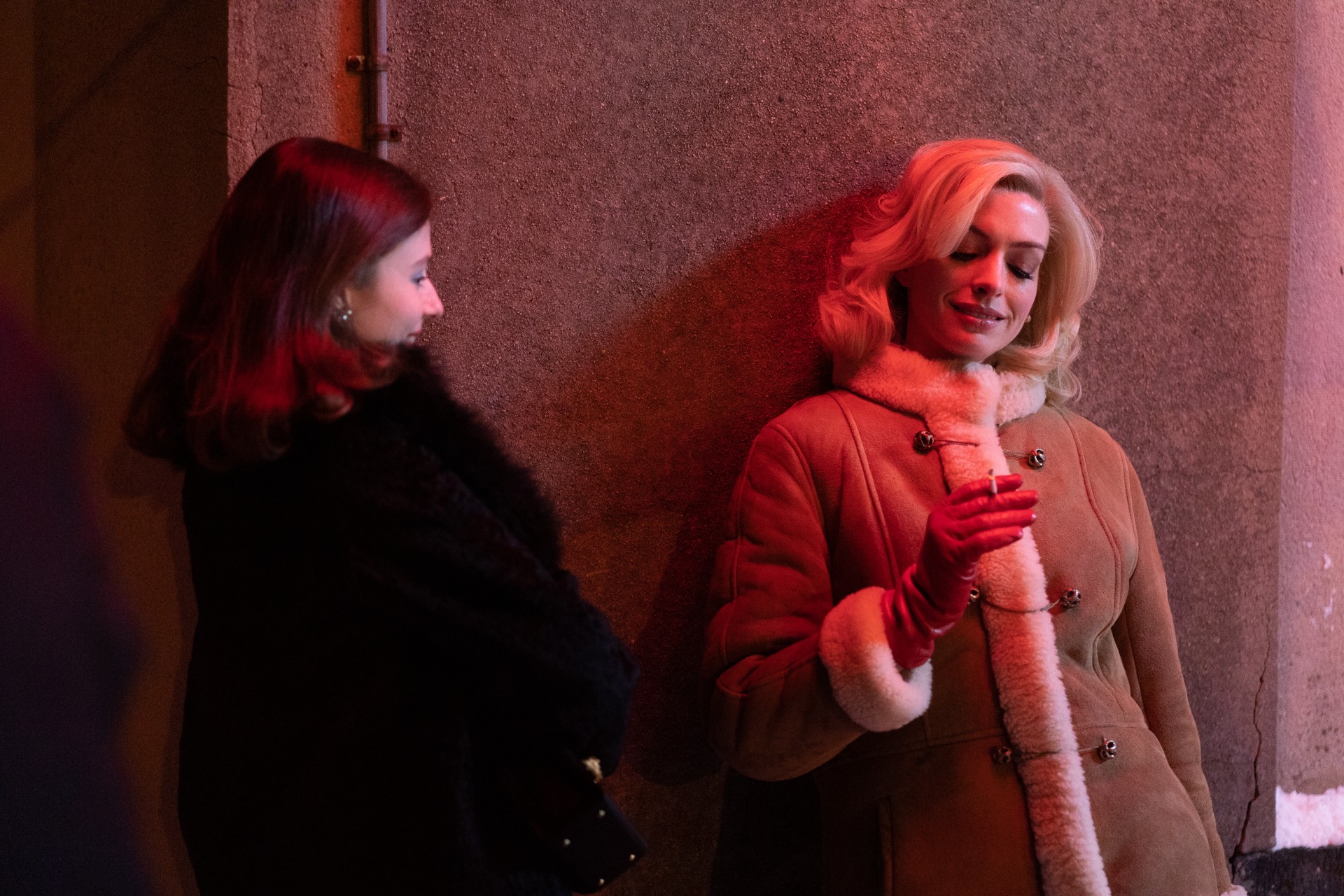 A woman smokes with another woman in Eileen.