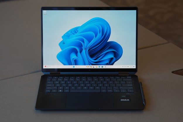 The HP Spectre x360 14 open on a table.