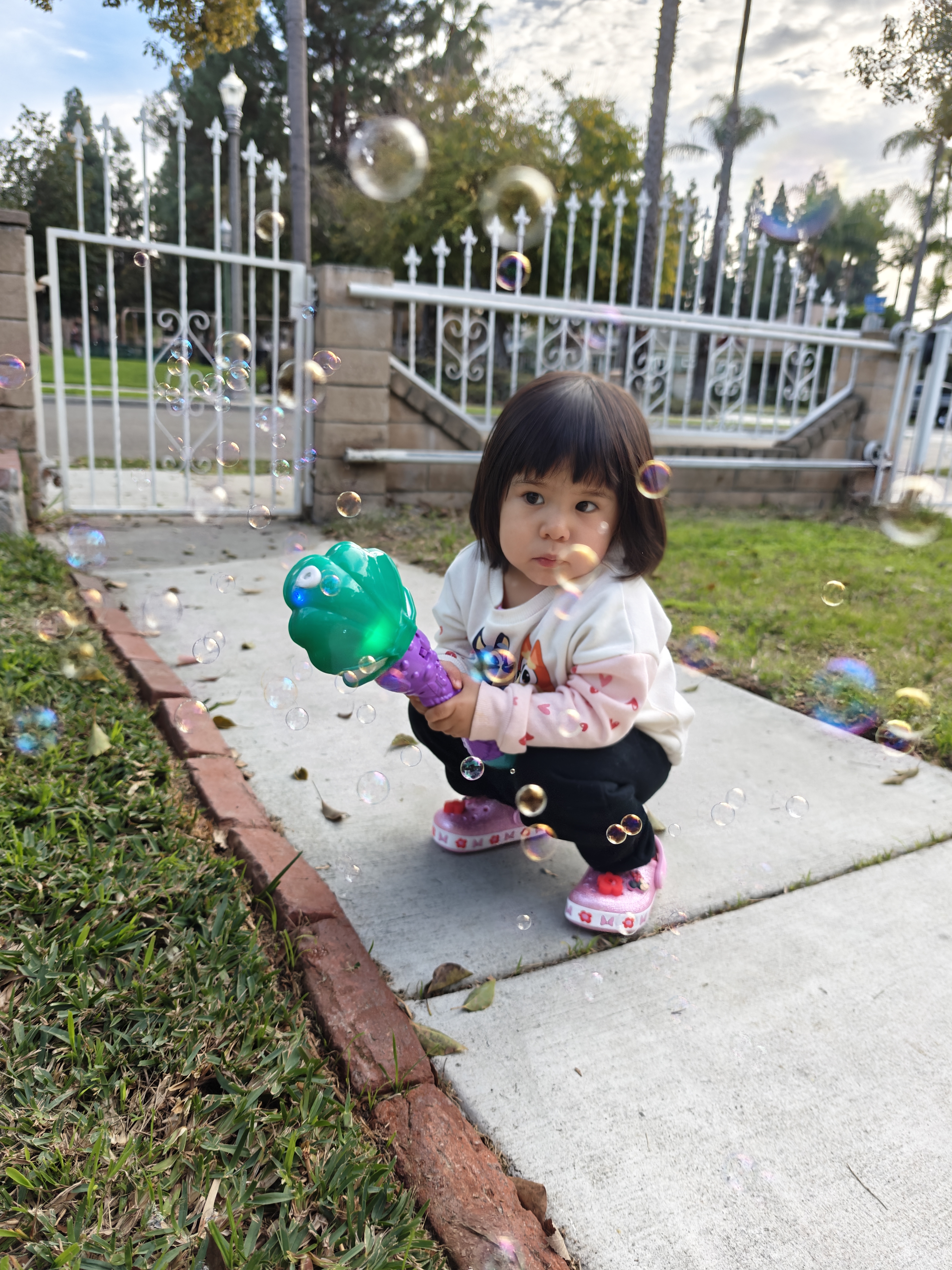 Girl playing with bubble wand taken with OnePlus 12.