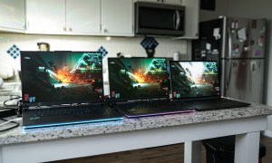 Three Asus laptops set up on a counter.