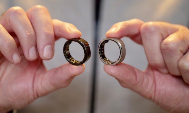 A person holding the RingConn Smart Ring and Oura Ring.