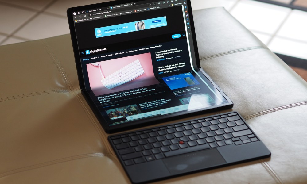 The ThinkPad X1 Fold unfolded on a couch, with the keyboard disconnected.