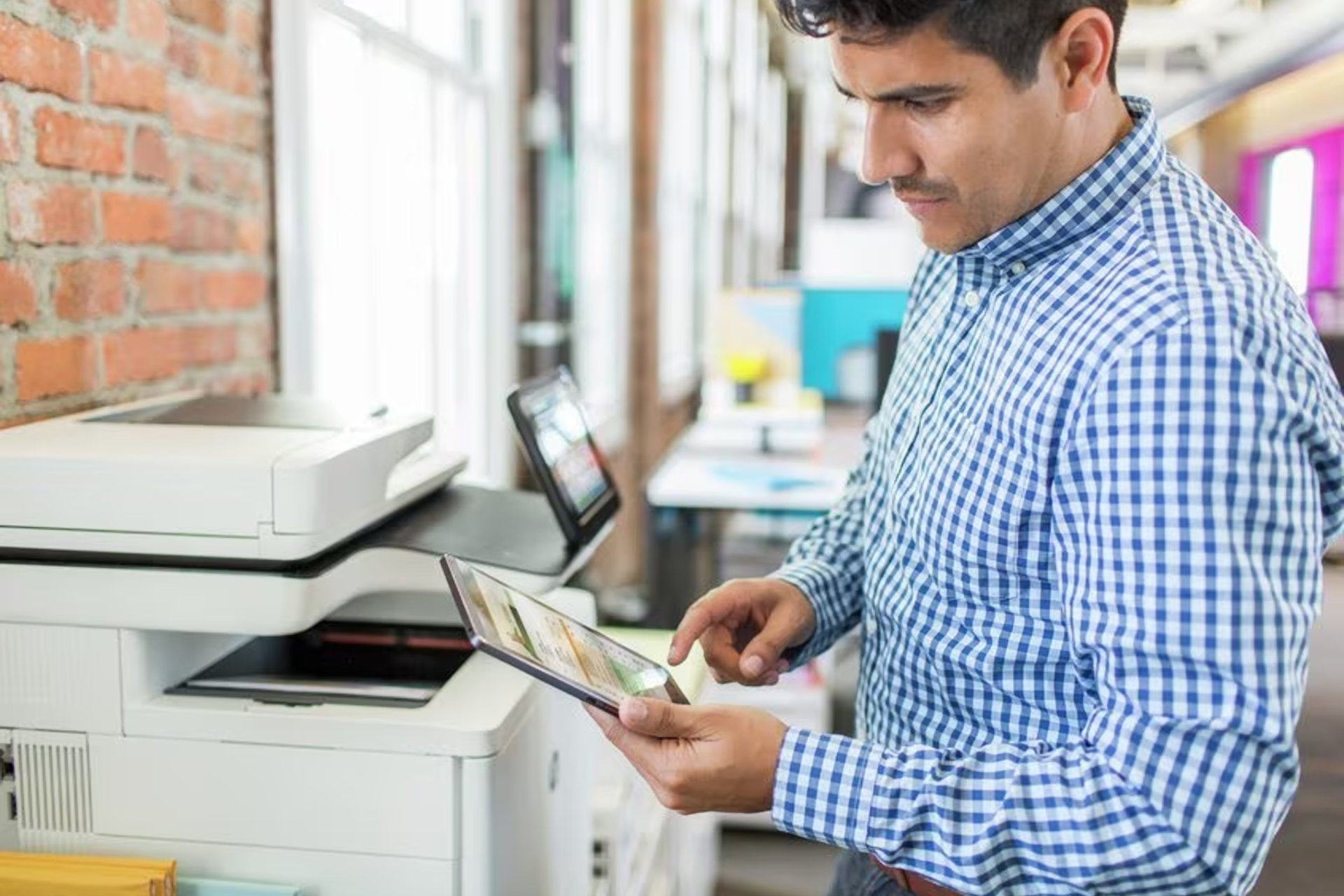 printer buying guide a person uses tablet with an hp laser in office