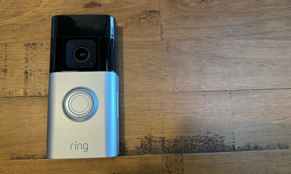 The Ring Battery Doorbell Pro on a wooden background.