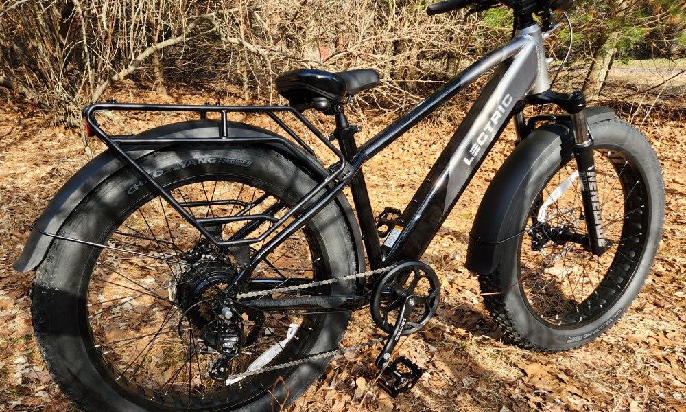 Lectric XPeak right rear three-quarter view parked on forest path