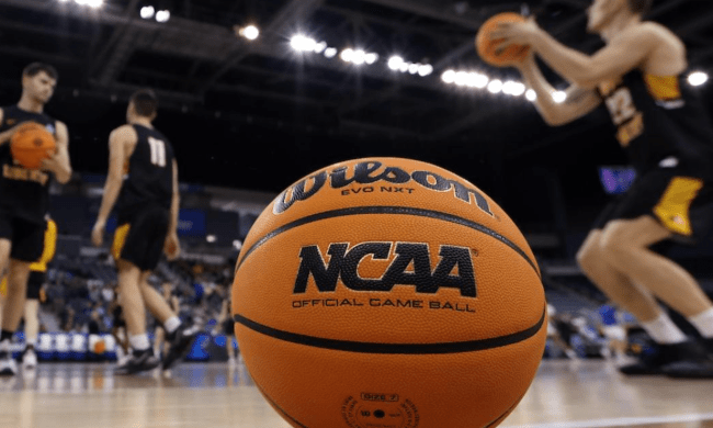 An NCAA basketball on the court.