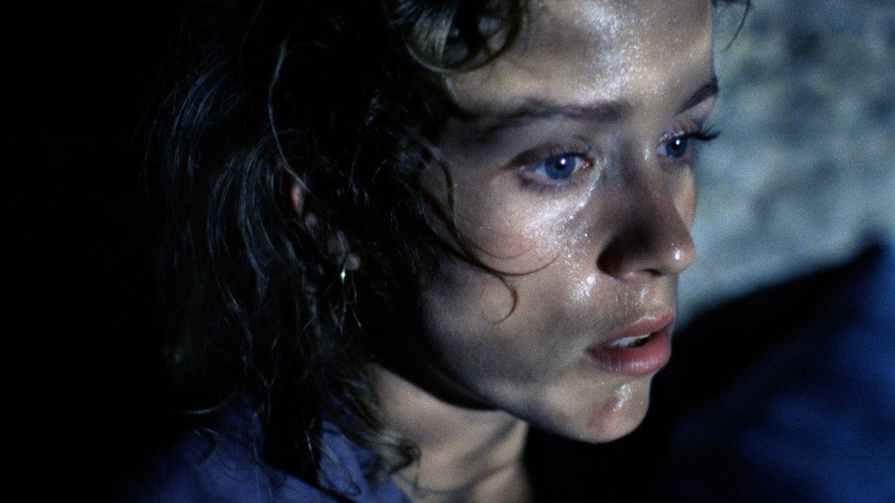 A woman stares at a window in Blood Simple.