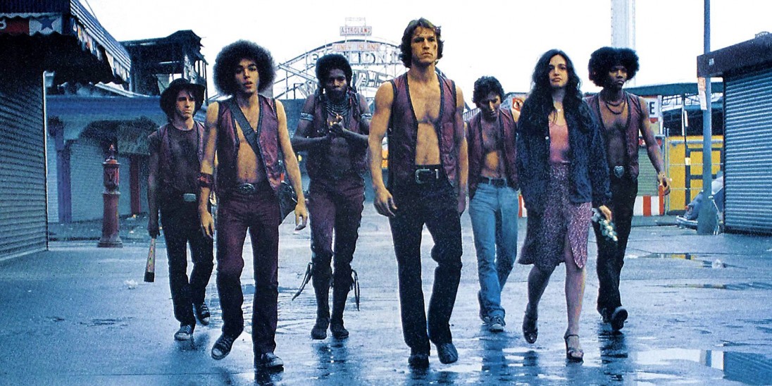 A gang walks a boardwalk in The Warriors.