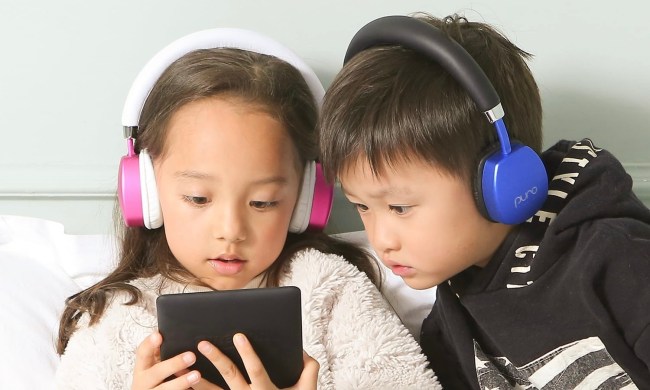 Two kids using the Puro Sound PuroQuiet Plus to watch something on a tablet.