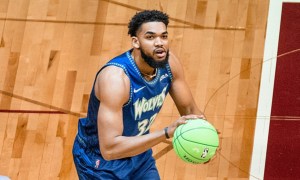 Karl-Anthony Towns holds a basketball and readies for a shot.