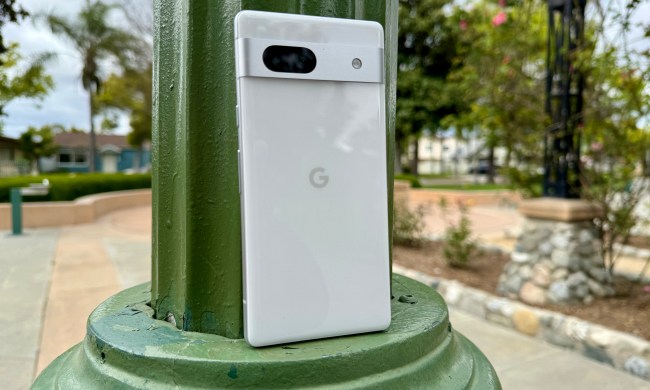 Google Pixel 7a in Snow leaning on lamp post.