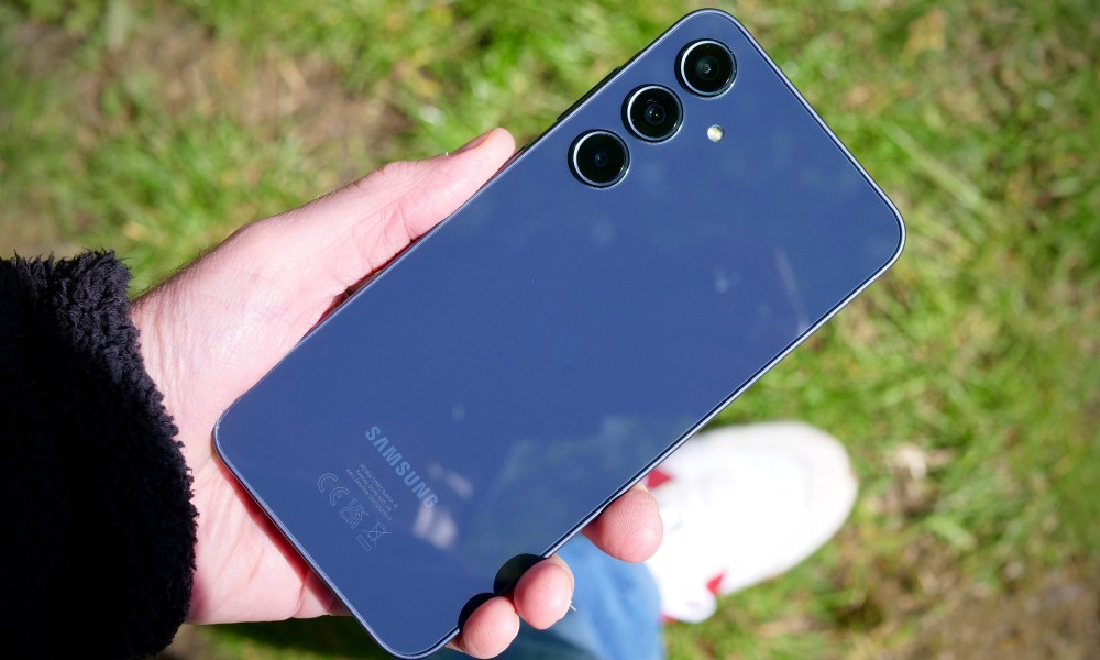 A person holding the Samsung Galaxy A35, showing the back of the phone.