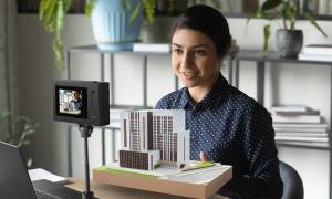 The SpatialLabs Eyes 3D camera being used in front of a woman.