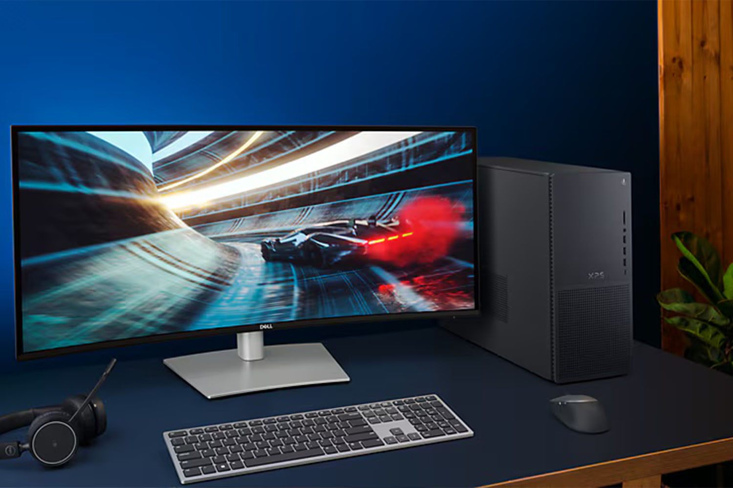 The Dell XPS Desktop on a desk next to a monitor.