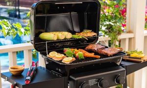 The Expert Grill 3-Burner Propane Gas Grill can tuck extra food in the opened lid.