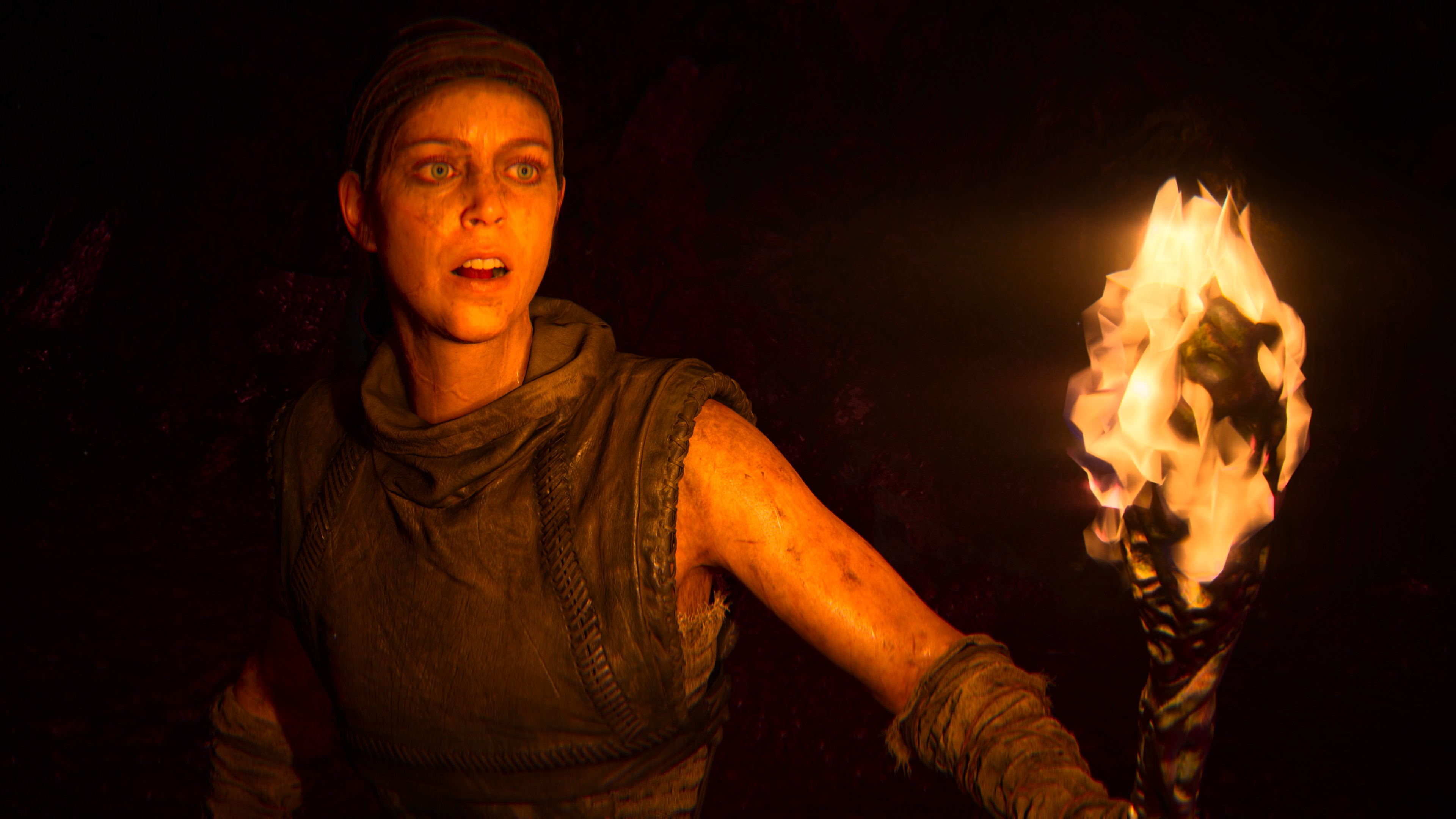 Senua carries a torch in Senua's Saga: Hellblade 2.