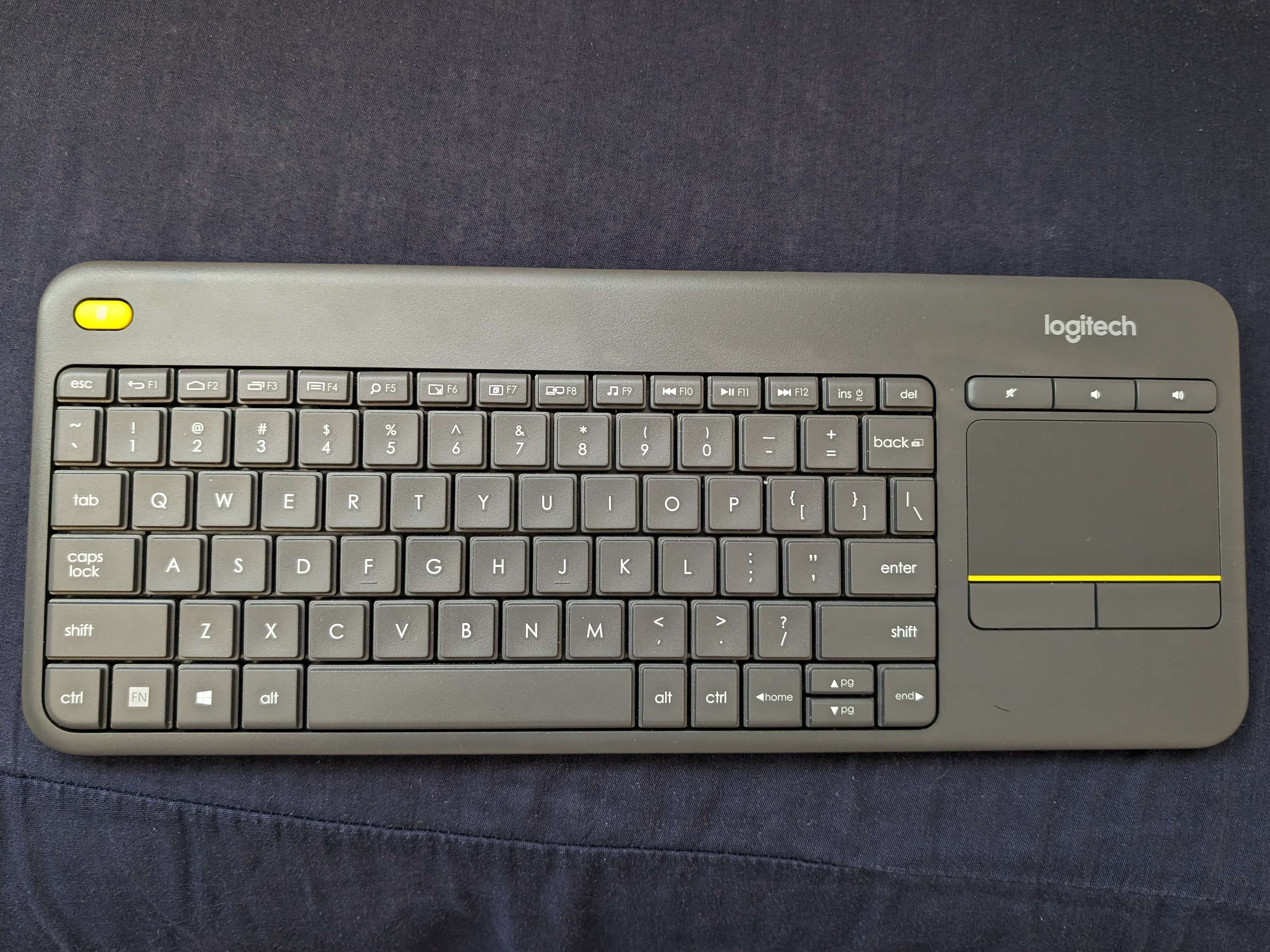 The Logitech K400 Plus on top of pillow.