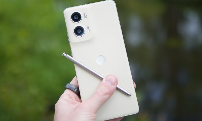 Someone holding the Moto G Stylus 5G (2024), showing the back of the phone and its stylus.