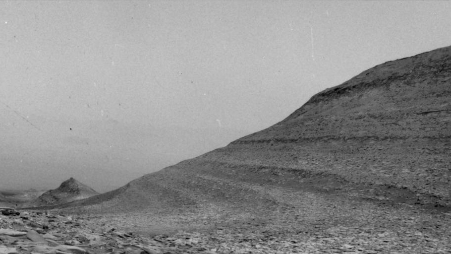 The specks in this scene were caused by charged particles from a solar storm hitting a camera aboard NASA’s Curiosity Mars rover. Curiosity uses its navigation cameras to try and capture images of dust devils and wind gusts, like the one seen here.