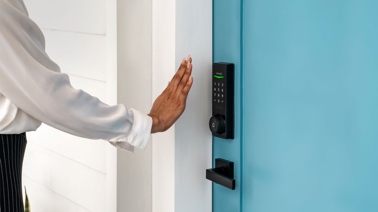 The Philips Palm Reader smart lock on a blue door.