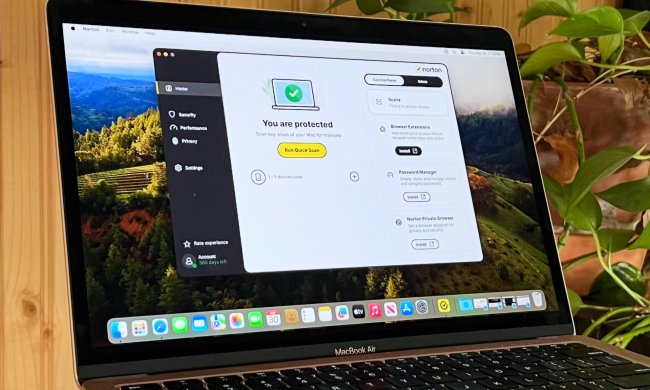 A MacBook Air runs Norton 360 Deluxe antivirus software.