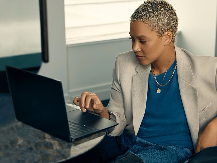 Dell Homepage woman working on laptop for Dell deals for summer