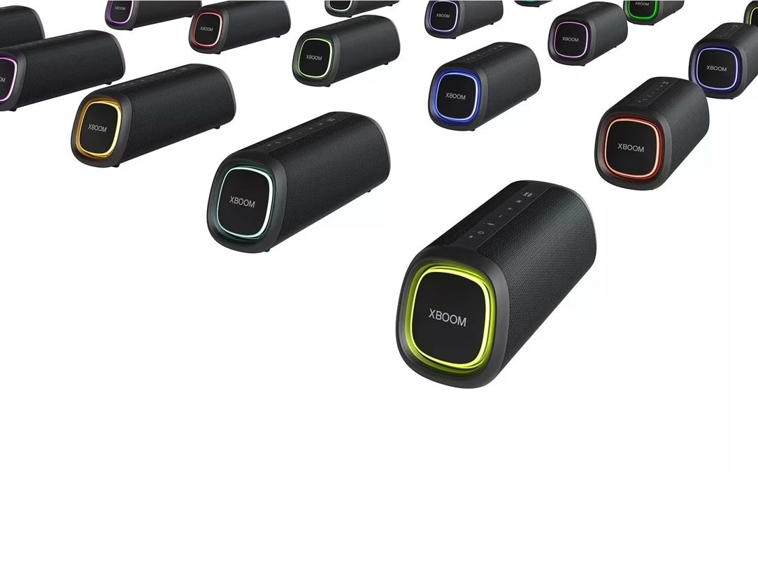 An array of LG XOOM Go XG5QBK speakers with their front lights all on different colors.